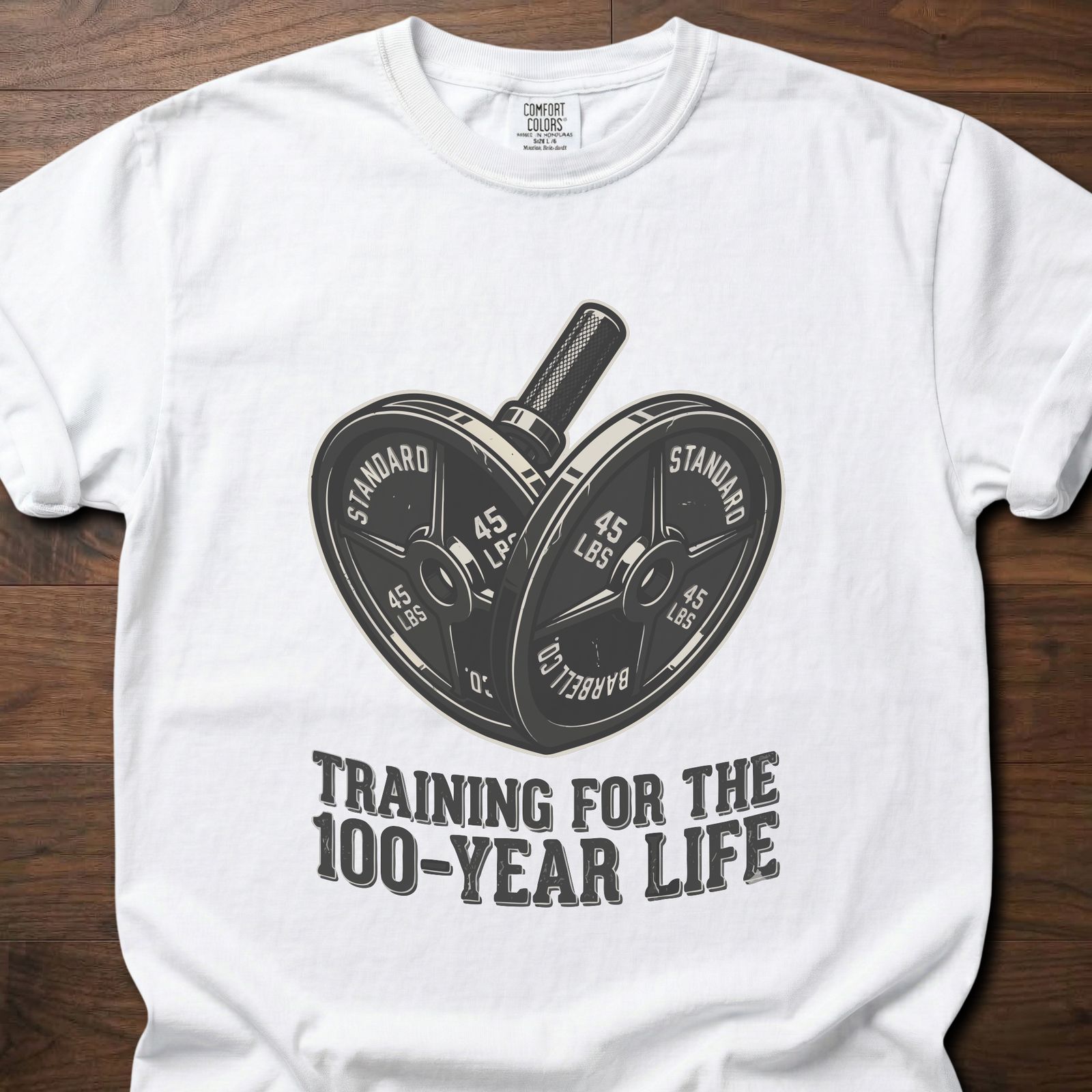 100-Year Life strength training t-shirt featuring heart-shaped weight plates and barbell design – White