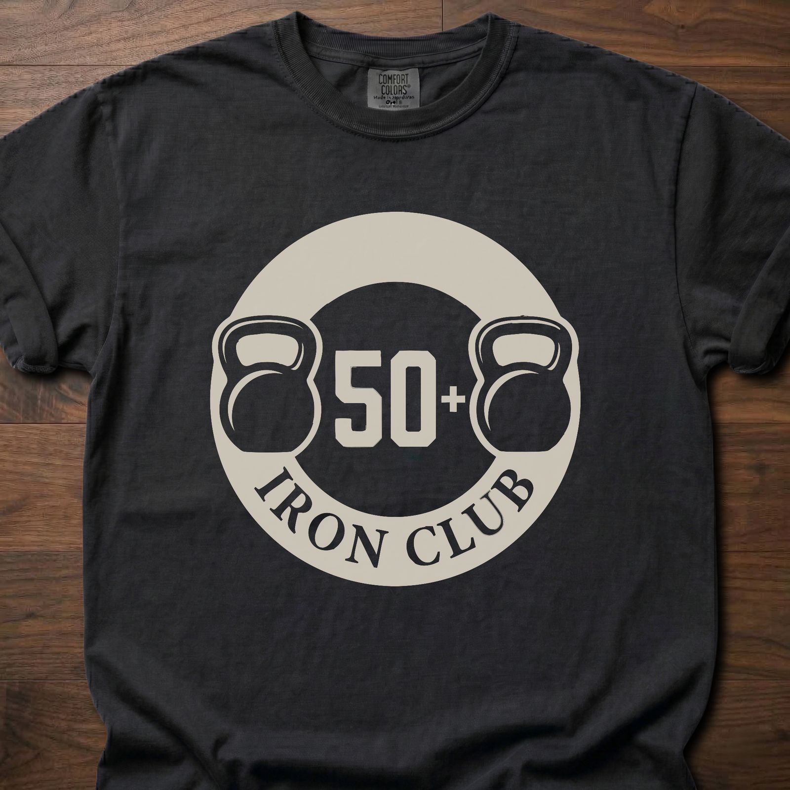 50+ Iron Club strength training t-shirt featuring kettlebells and circular badge design – Black