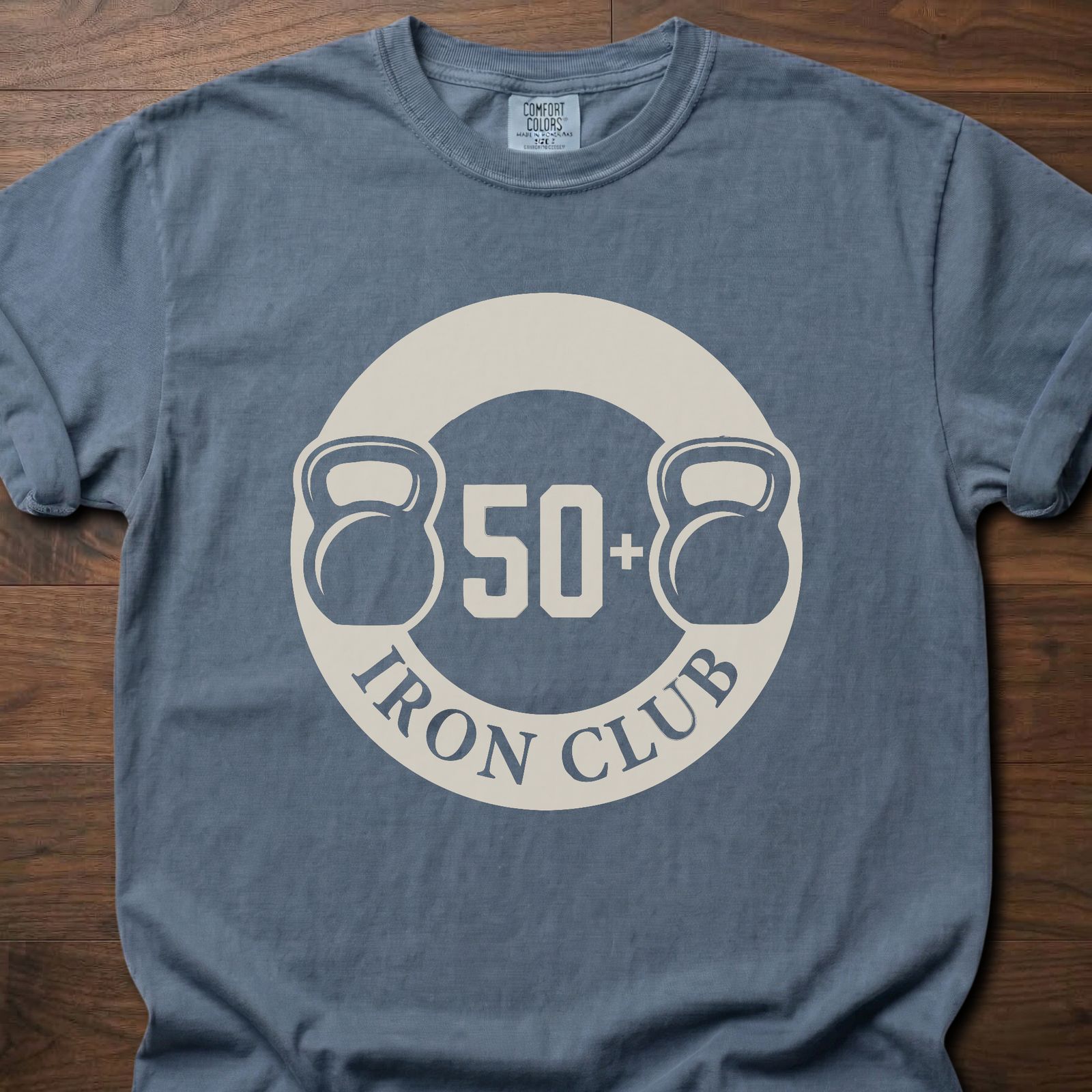 50+ Iron Club strength training t-shirt featuring kettlebells and circular badge design – Blue Jean