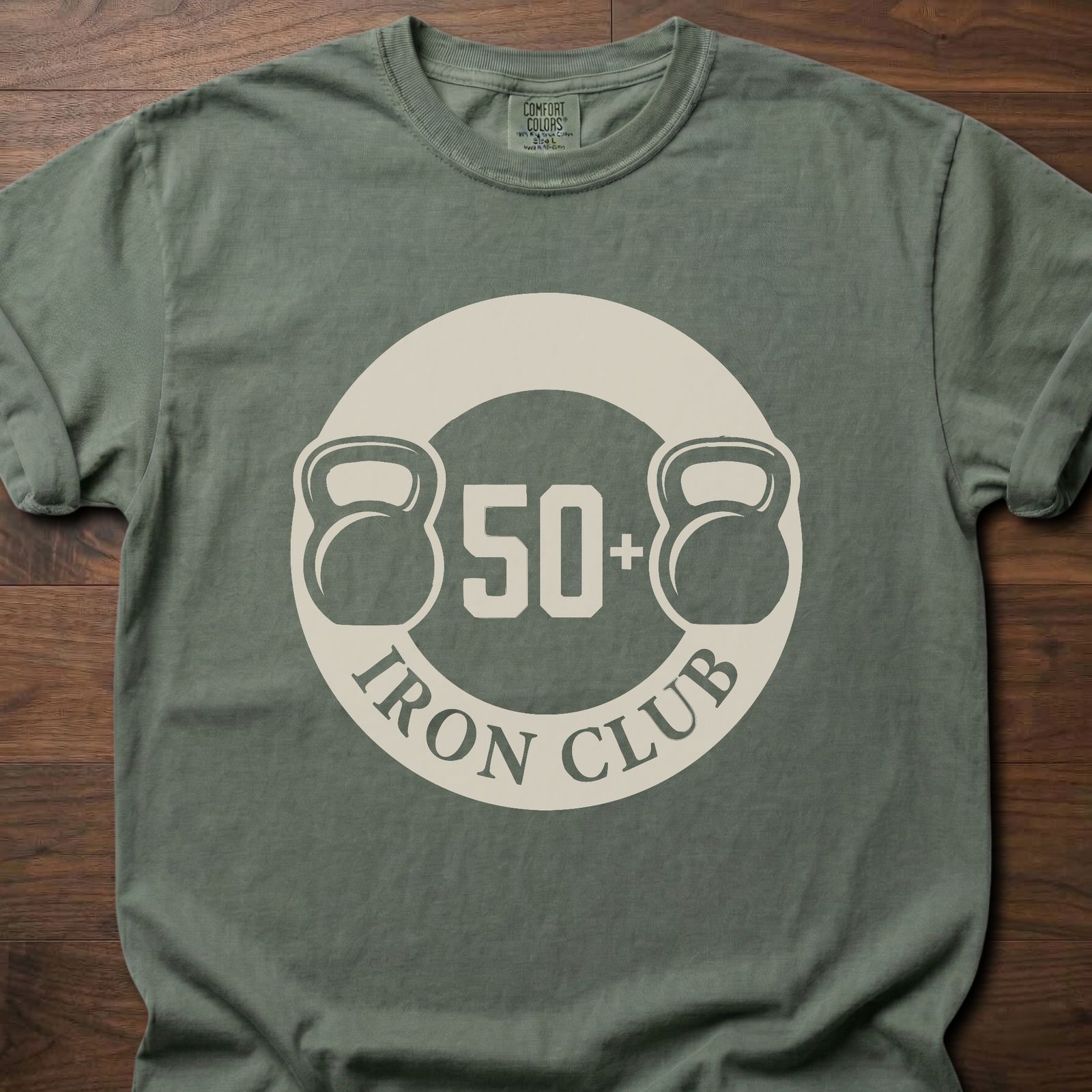 50+ Iron Club strength training t-shirt featuring kettlebells and circular badge design – Moss