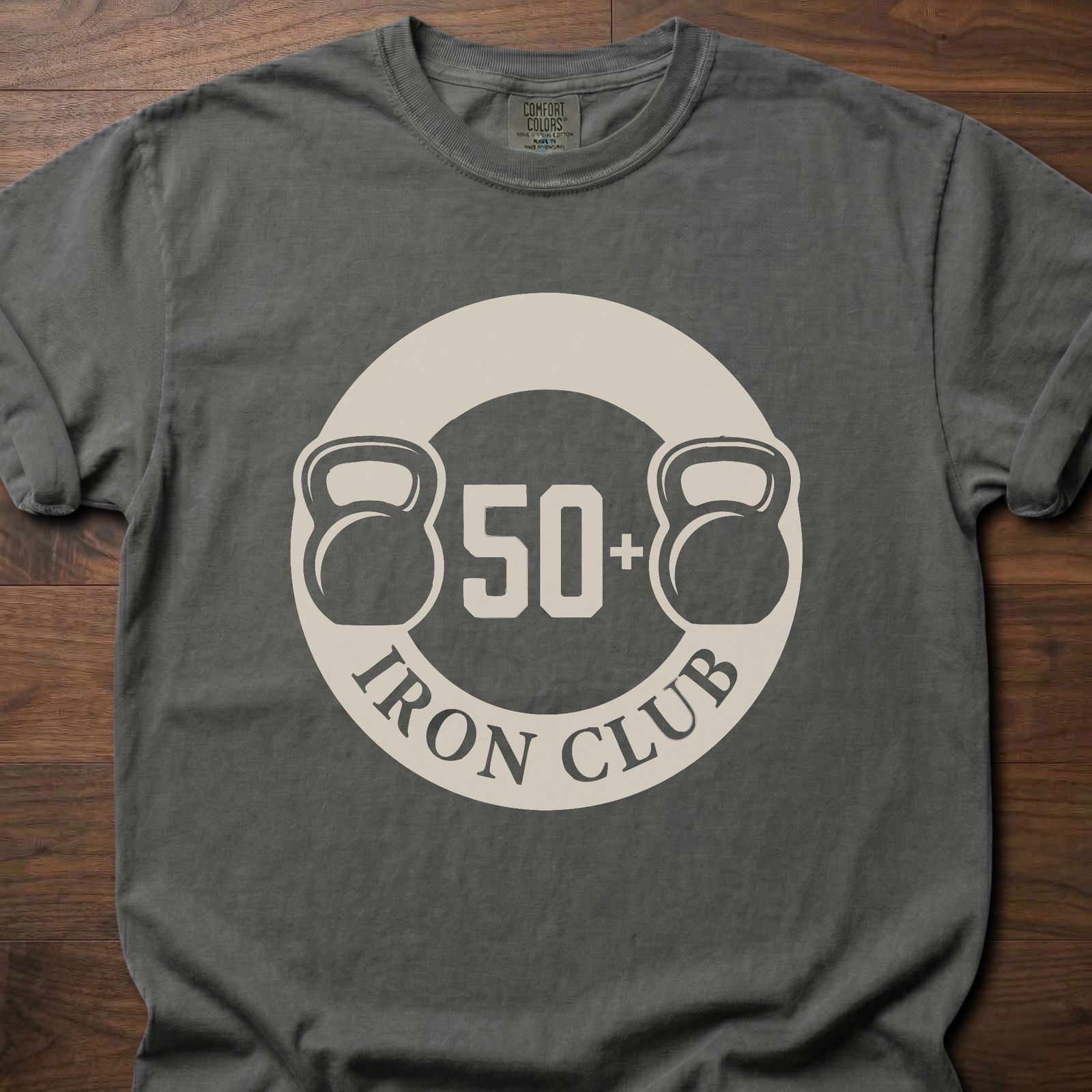 50+ Iron Club strength training t-shirt featuring kettlebells and circular badge design – Pepper