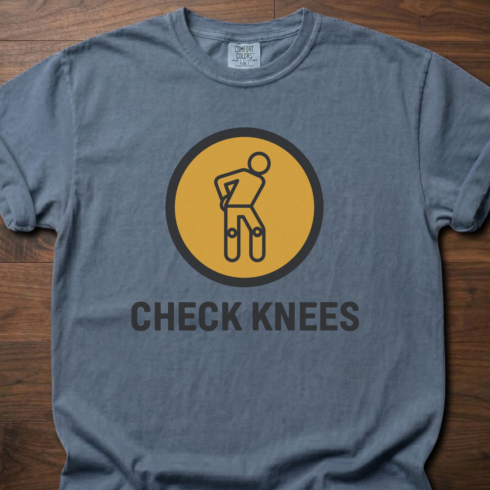 Check Knees strength training t-shirt with figure holding knee in circular badge design – Blue Jean