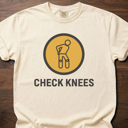 Check Knees strength training t-shirt with figure holding knee in circular badge design – Ivory