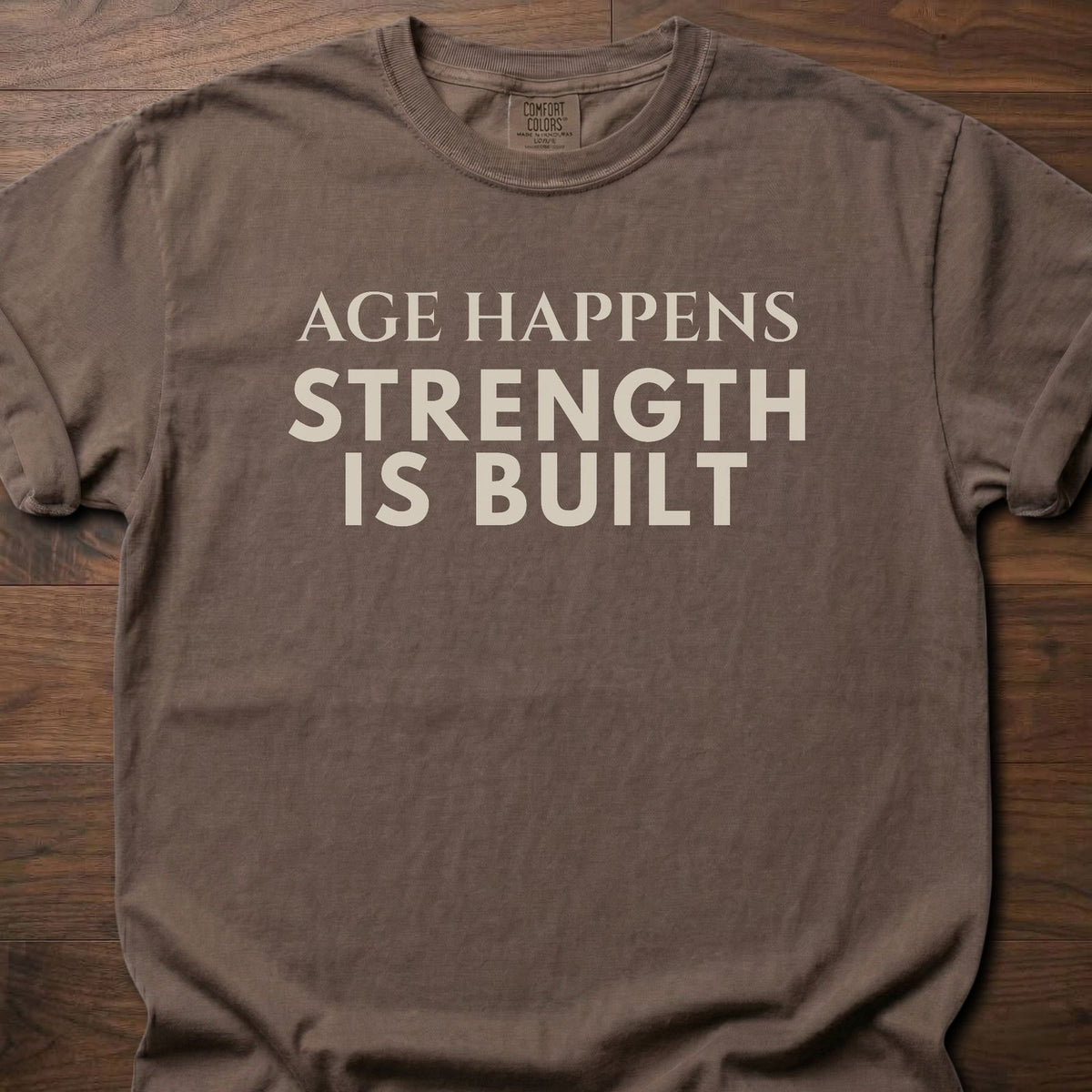 Age Happens strength training t-shirt with clean bold typographic graphic – Espresso