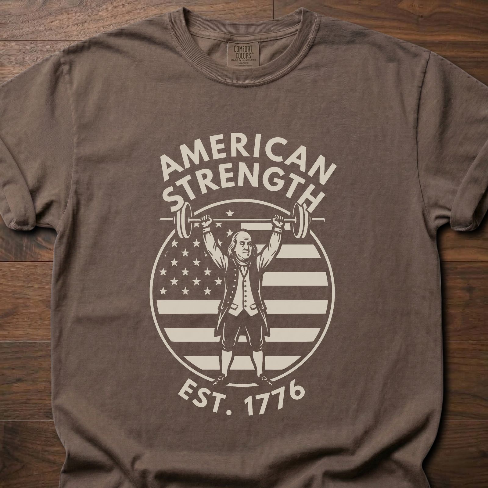 American Strength strength training t-shirt featuring Benjamin Franklin lifting barbell with flag design – Espresso
