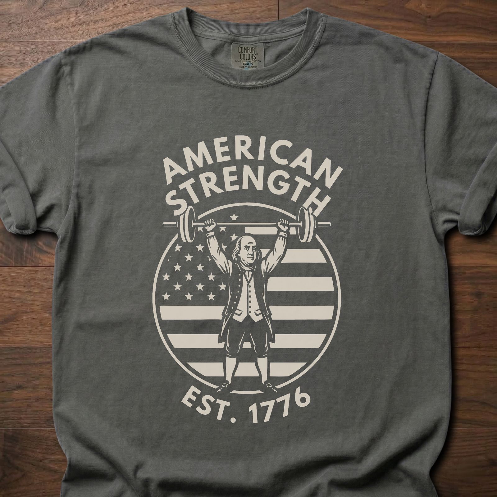 American Strength strength training t-shirt featuring Benjamin Franklin lifting barbell with flag design – Pepper