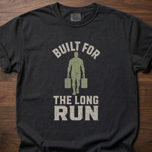 Built For The Long Run fitness lifestyle t-shirt with a figure carrying loaded farmer's walk handles – Black