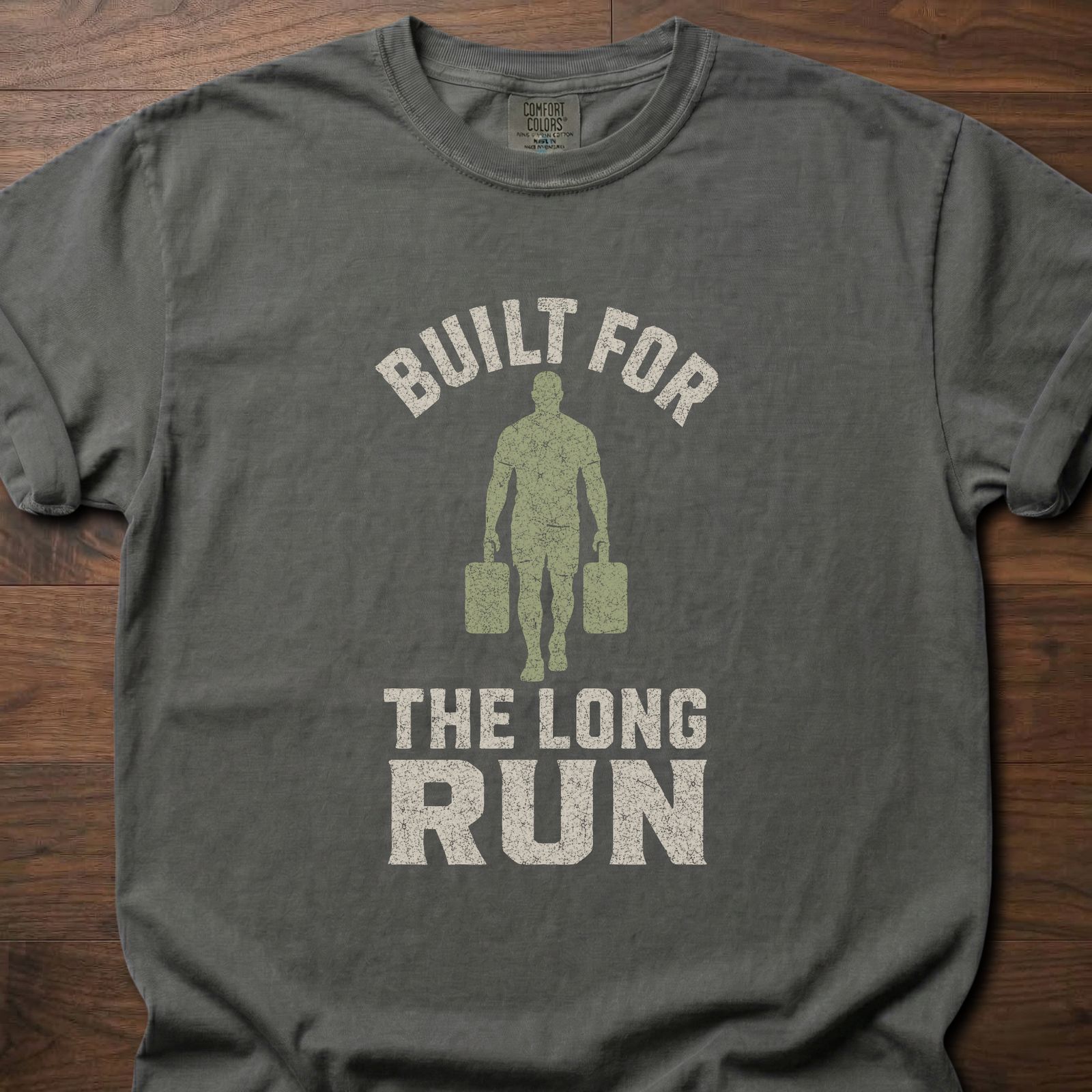 Built For The Long Run fitness lifestyle t-shirt with a figure carrying loaded farmer's walk handles – Pepper