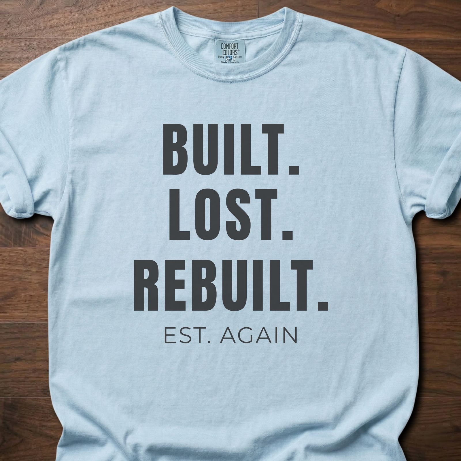 Built Lost Rebuilt strength training lifestyle clothing with resilience message EST. AGAIN tagline – Chambray