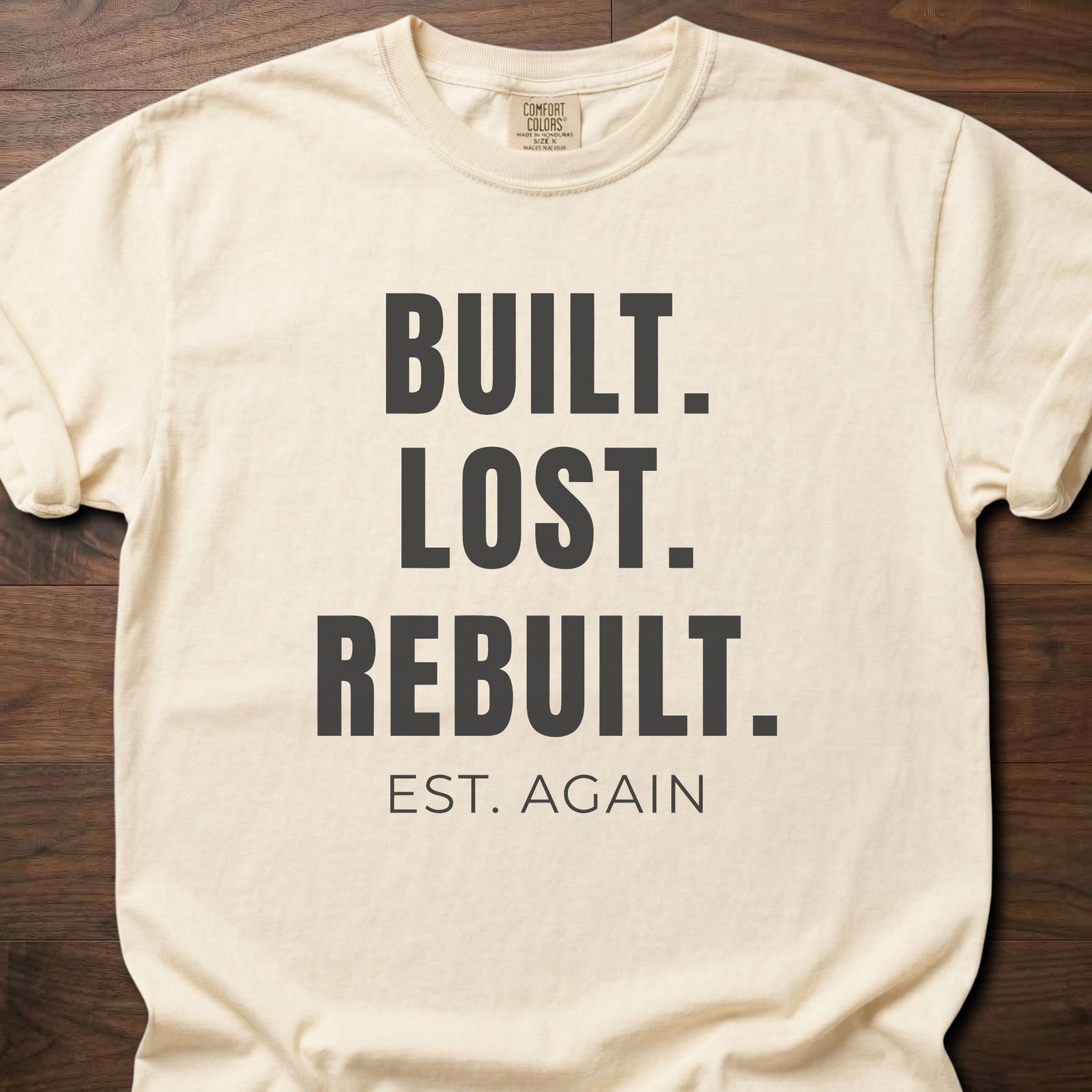 Built Lost Rebuilt strength training lifestyle clothing with resilience message EST. AGAIN tagline – Ivory