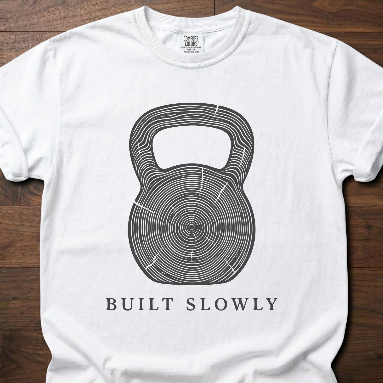 Built Slowly fitness lifestyle t shirt featuring kettlebell with tree ring growth pattern design – White