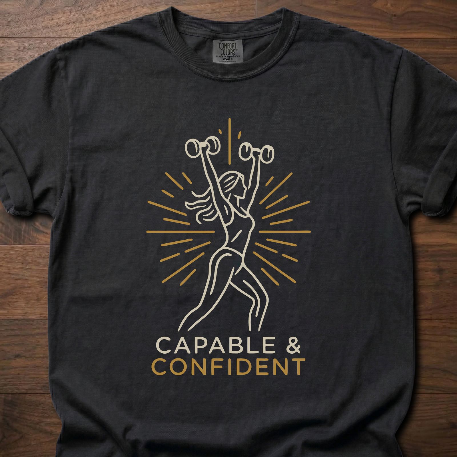 Capable & Confident fitness lifestyle t shirts featuring woman with dumbbells and radiant burst design – Black