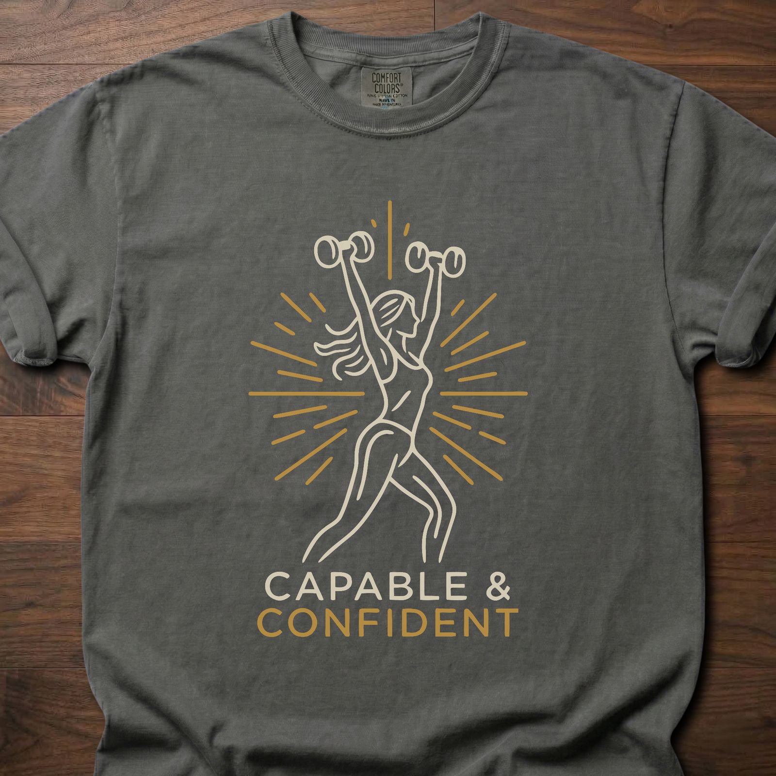 Capable & Confident fitness lifestyle t shirts featuring woman with dumbbells and radiant burst design – Pepper