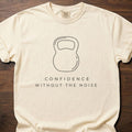 Confidence Without The Noise gym lifestyle shirt featuring minimalist kettlebell outline design – Ivory