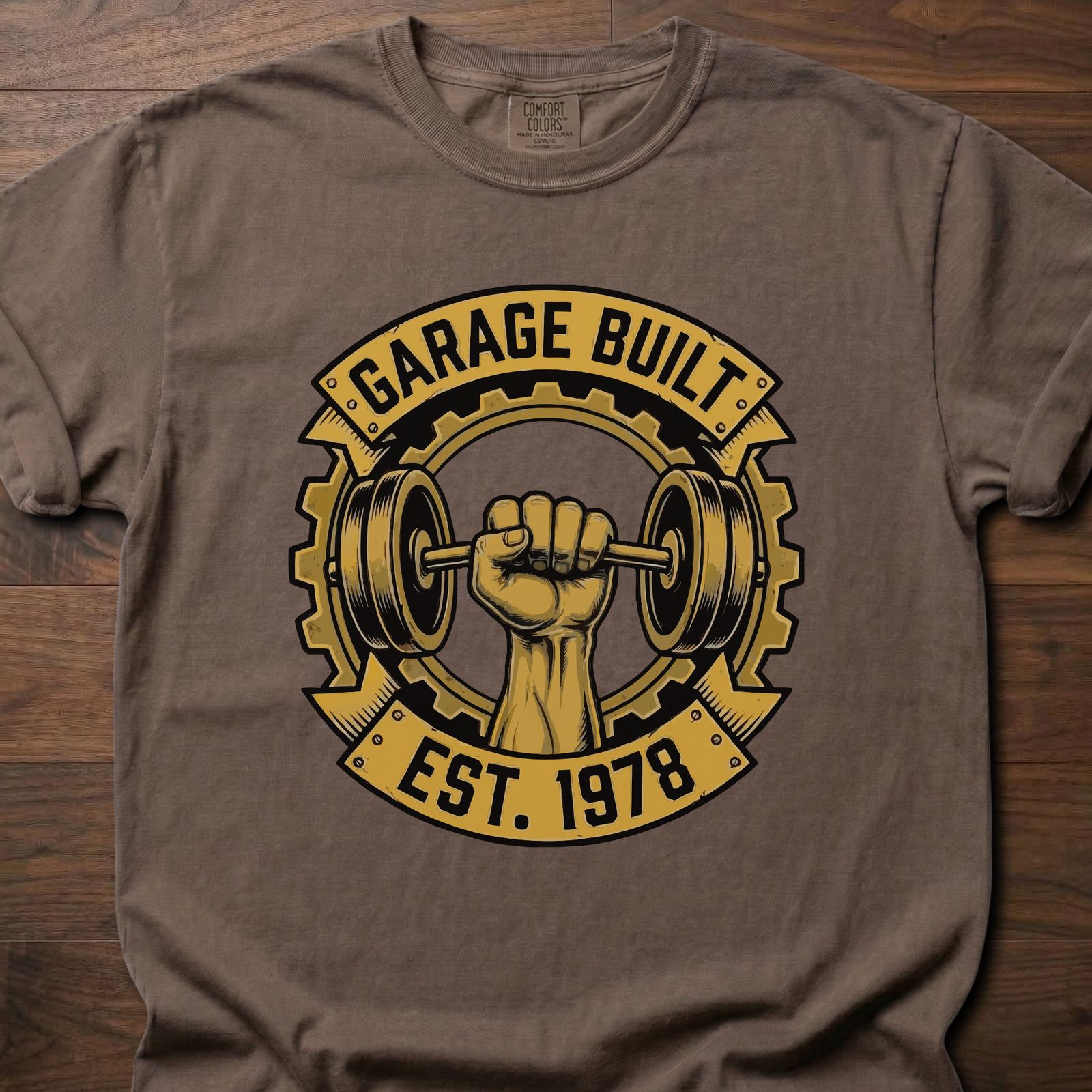 Garage Built gym lifestyle shirt featuring muscular fist gripping barbell with gear emblem EST. 1978 – Espresso