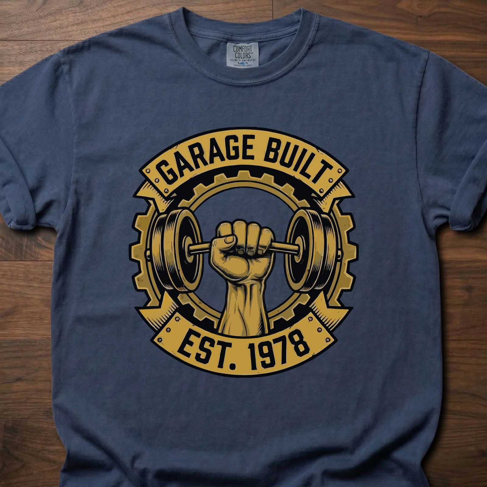 Garage Built gym lifestyle shirt featuring muscular fist gripping barbell with gear emblem EST. 1978 – Navy