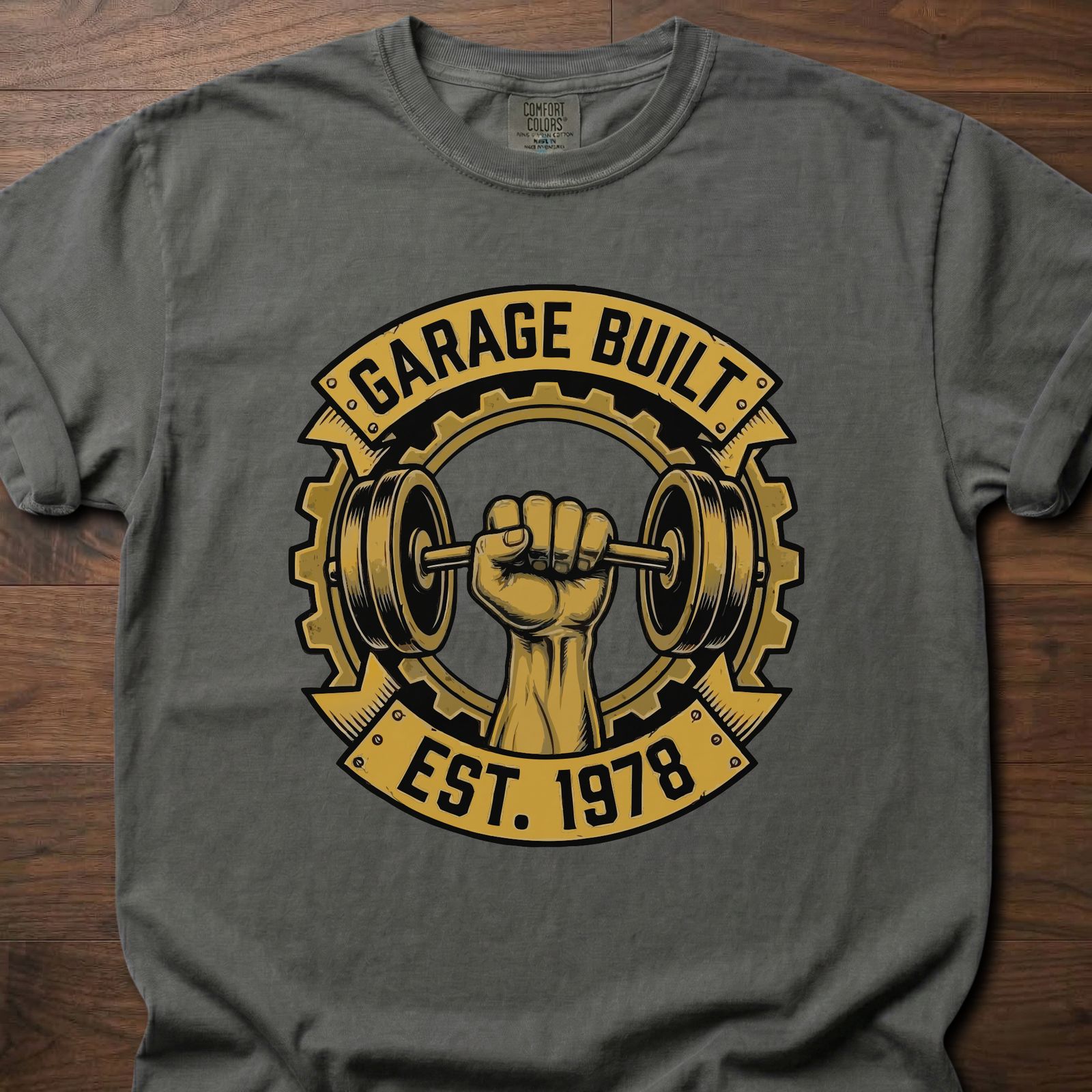 Garage Built gym lifestyle shirt featuring muscular fist gripping barbell with gear emblem EST. 1978 – Pepper