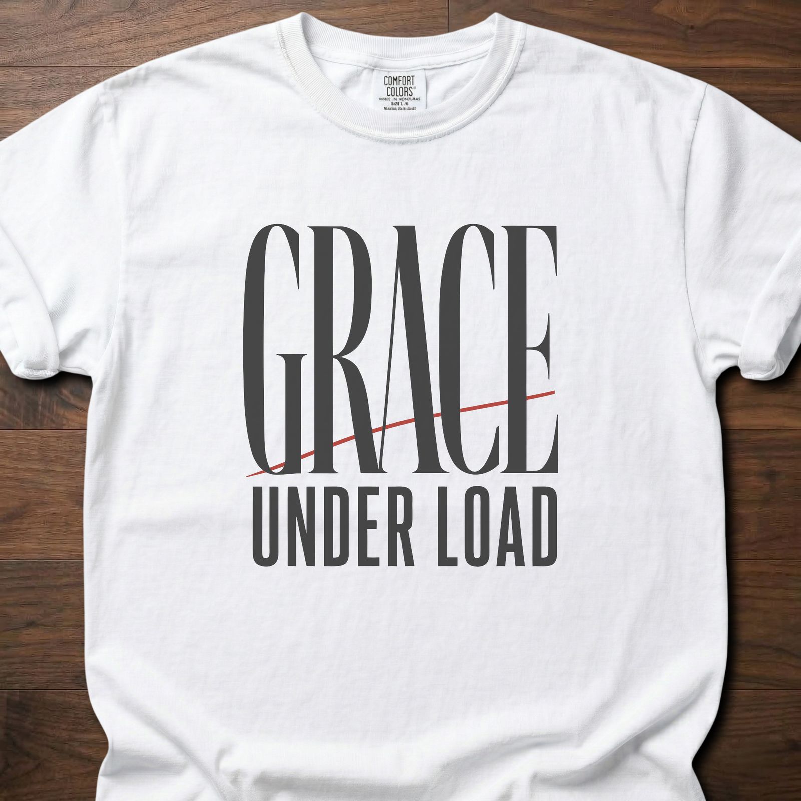 Grace Under Load strength training t-shirt with bold typography and red accent line design – White