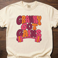 Granny Got Gains funny gym shirt with bold retro bubble-letter graphic and barbell – Ivory