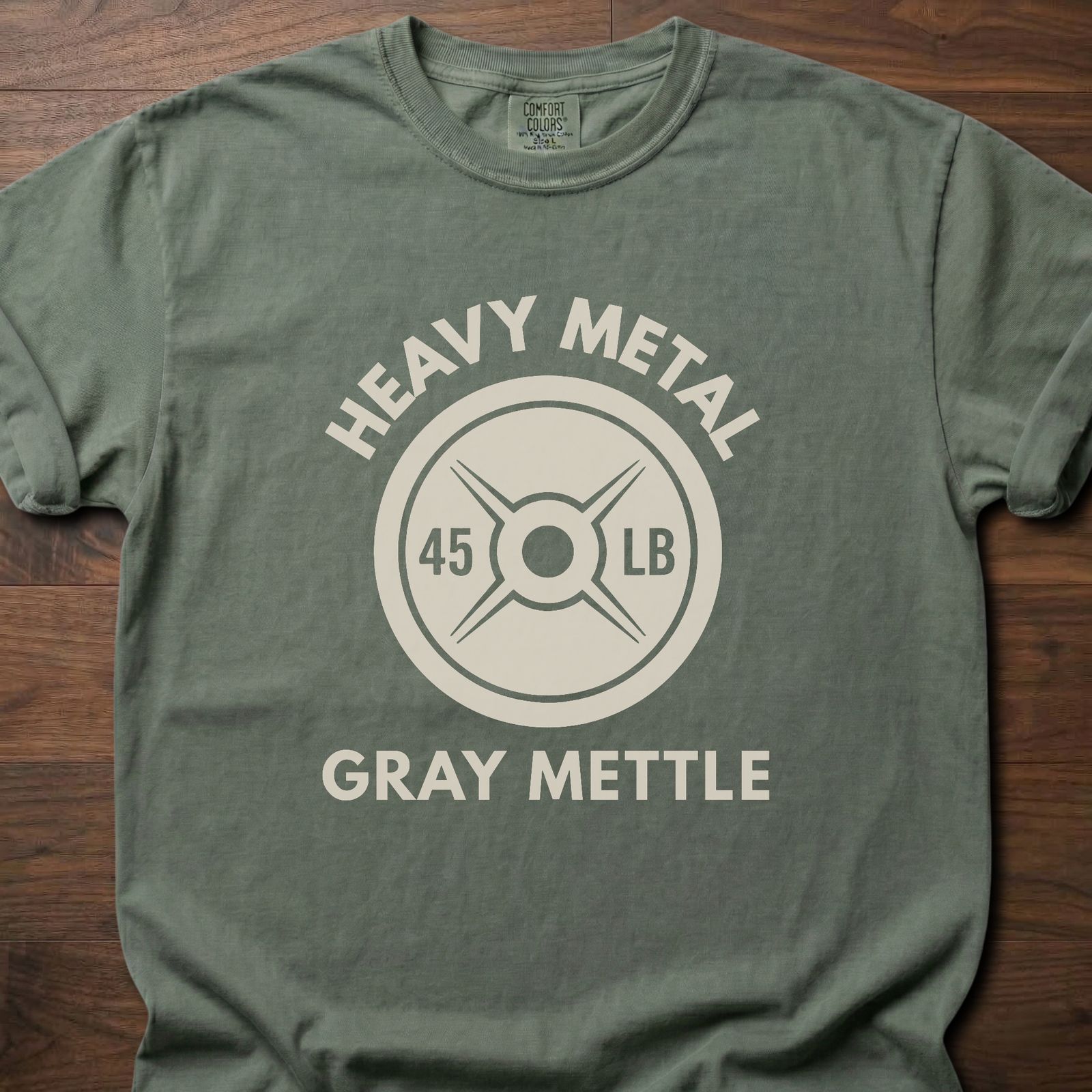 Gray Mettle strength training t-shirt featuring 45 lb weight plate design with Heavy Metal text – Moss