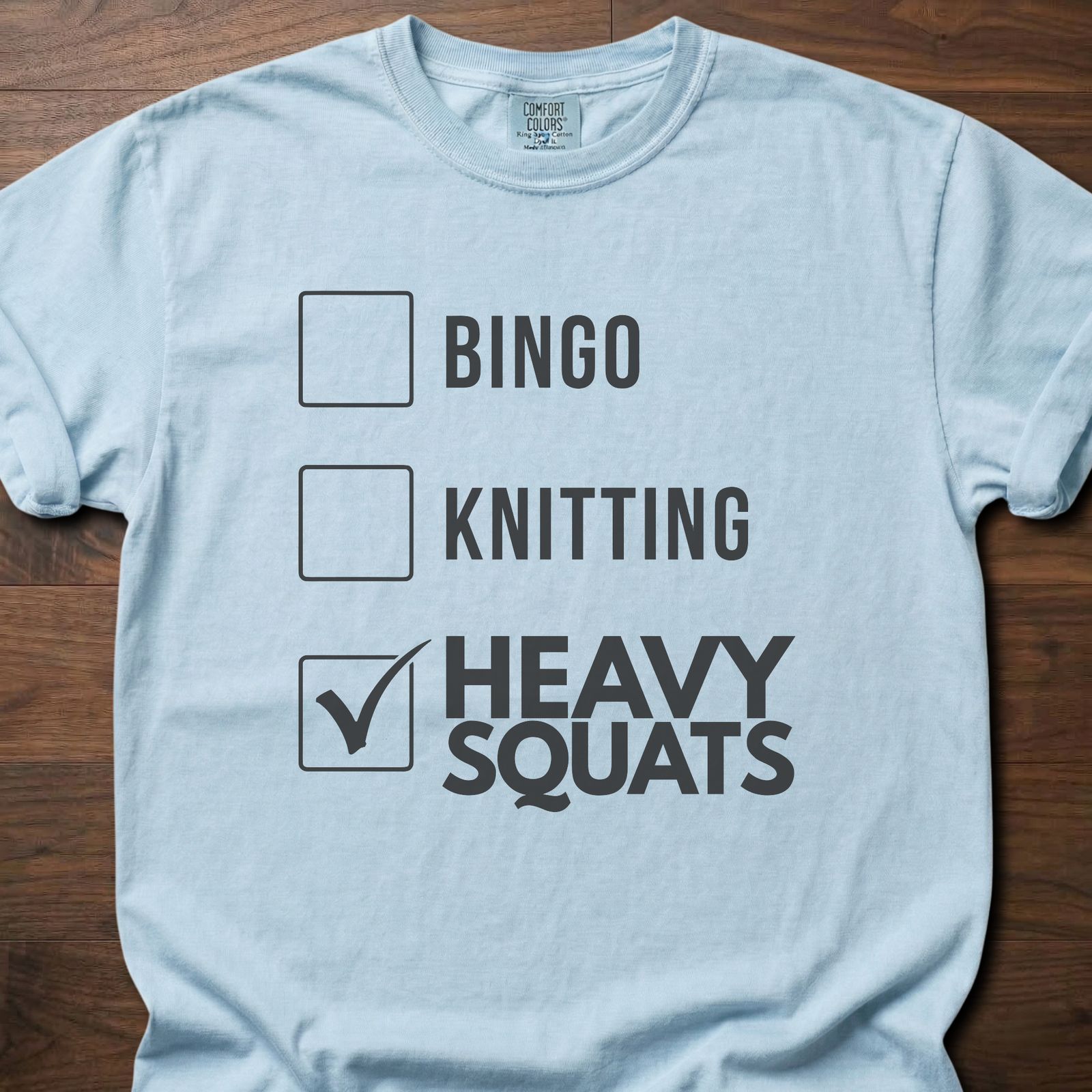 Heavy Squats strength training t-shirt with checkbox list showing heavy squats selected – Chambray