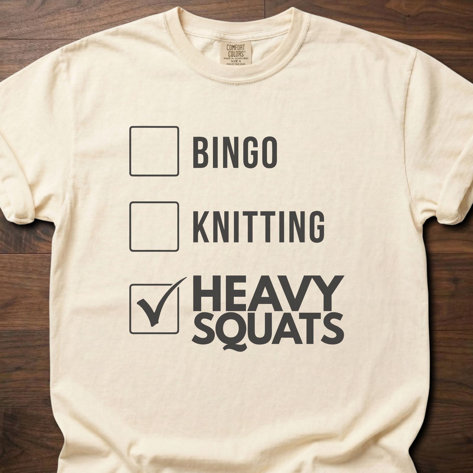 Heavy Squats strength training t-shirt with checkbox list showing heavy squats selected – Ivory