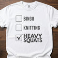 Heavy Squats strength training t-shirt with checkbox list showing heavy squats selected – White