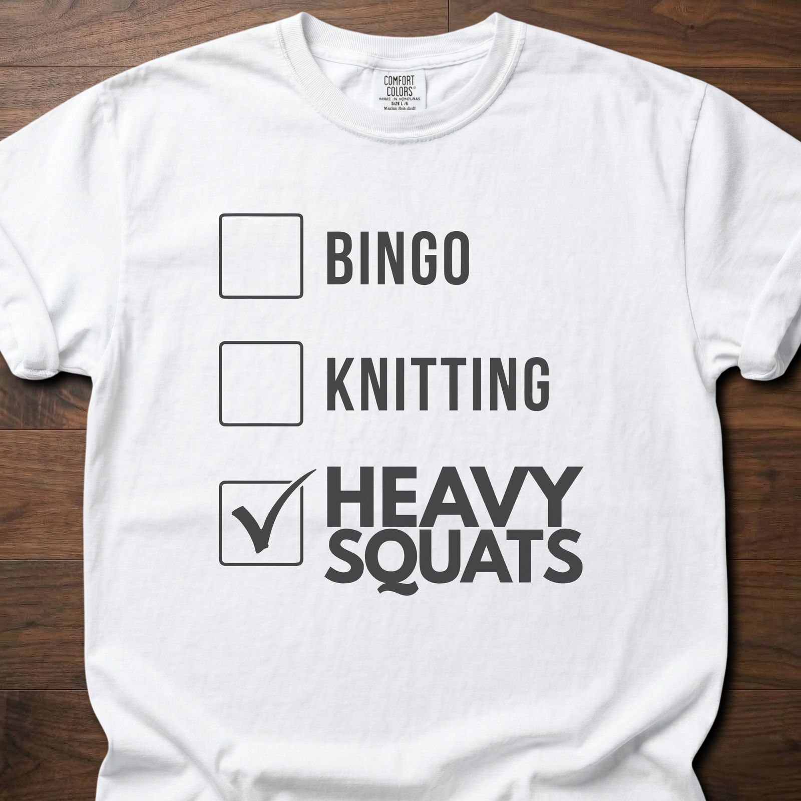 Heavy Squats strength training t-shirt with checkbox list showing heavy squats selected – White
