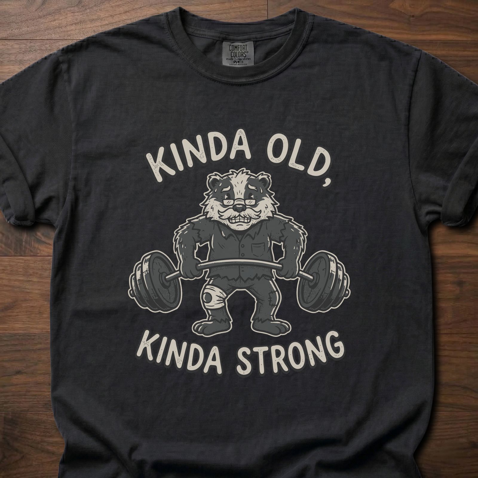 Kinda Old Kinda Strong strength training t shirt featuring weightlifting badger with barbell – Black