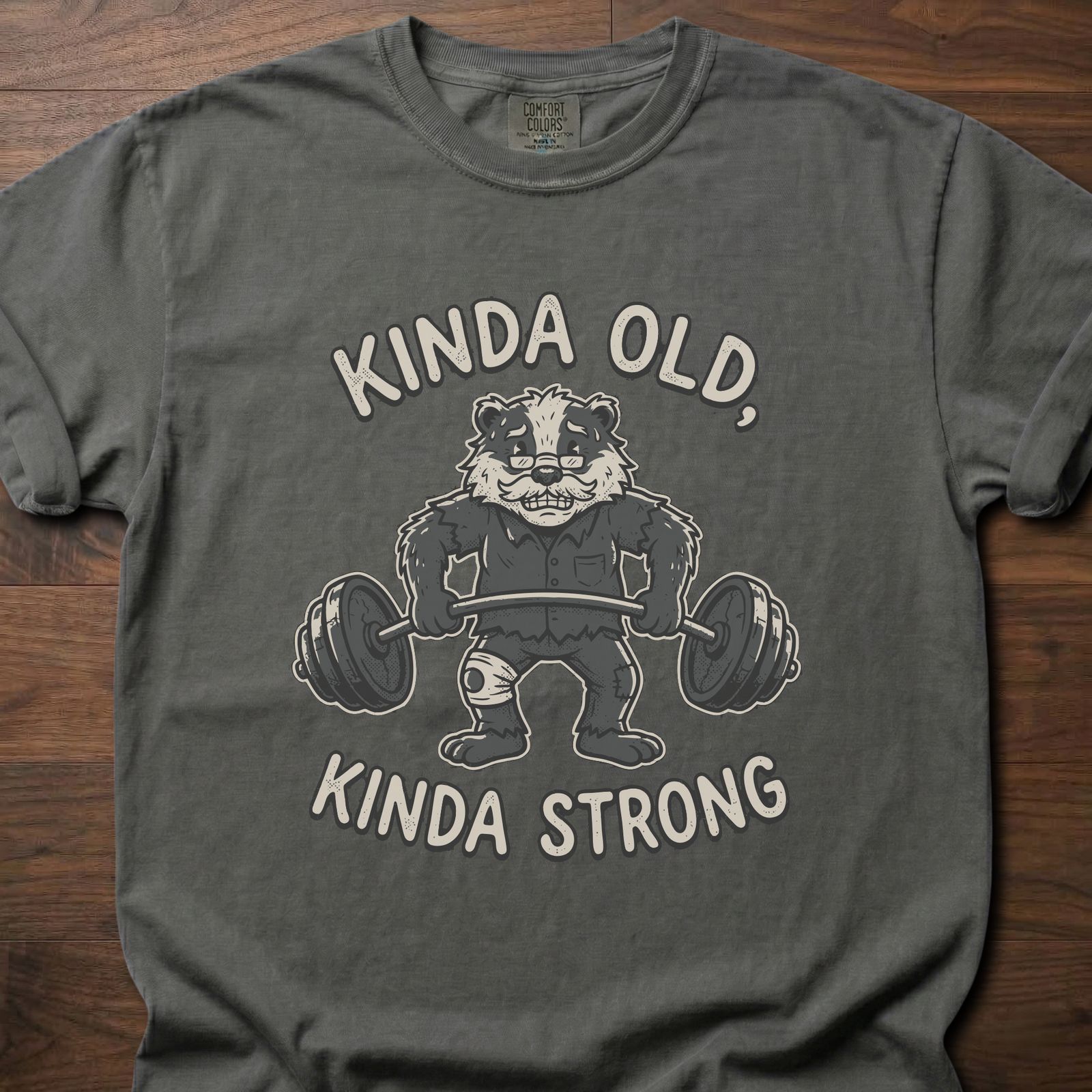 Kinda Old Kinda Strong strength training t shirt featuring weightlifting badger with barbell – Pepper
