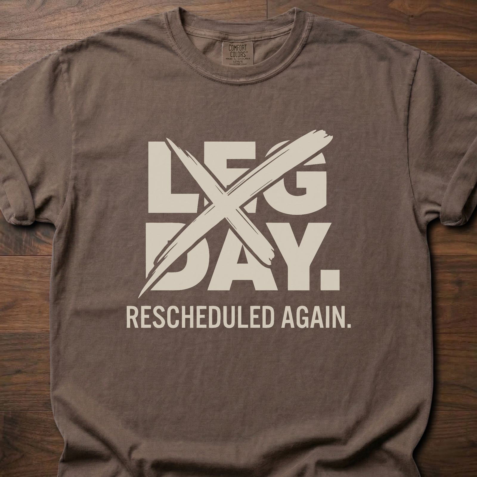 Leg Day strength training t-shirt with crossed out leg day and rescheduled again text – Espresso