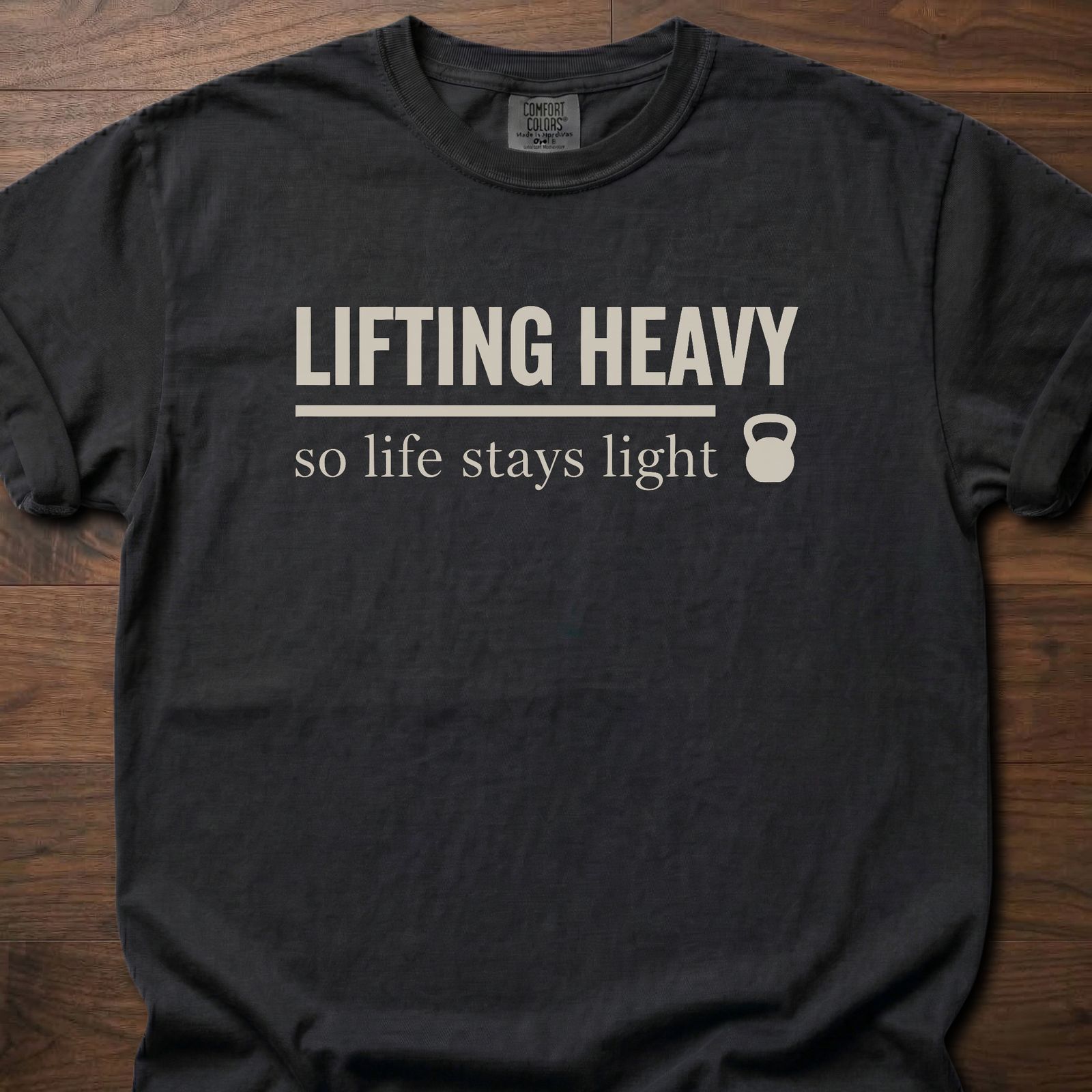 Life Stays Light strength training t shirt with kettlebell and motivational lifting message – Black