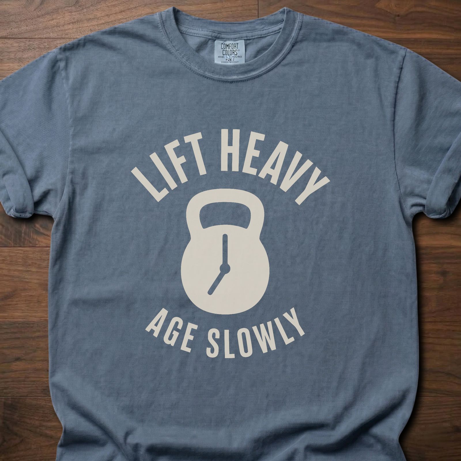 Lift Heavy Age Slowly strength training t-shirt with kettlebell and clock hands graphic – Blue Jean