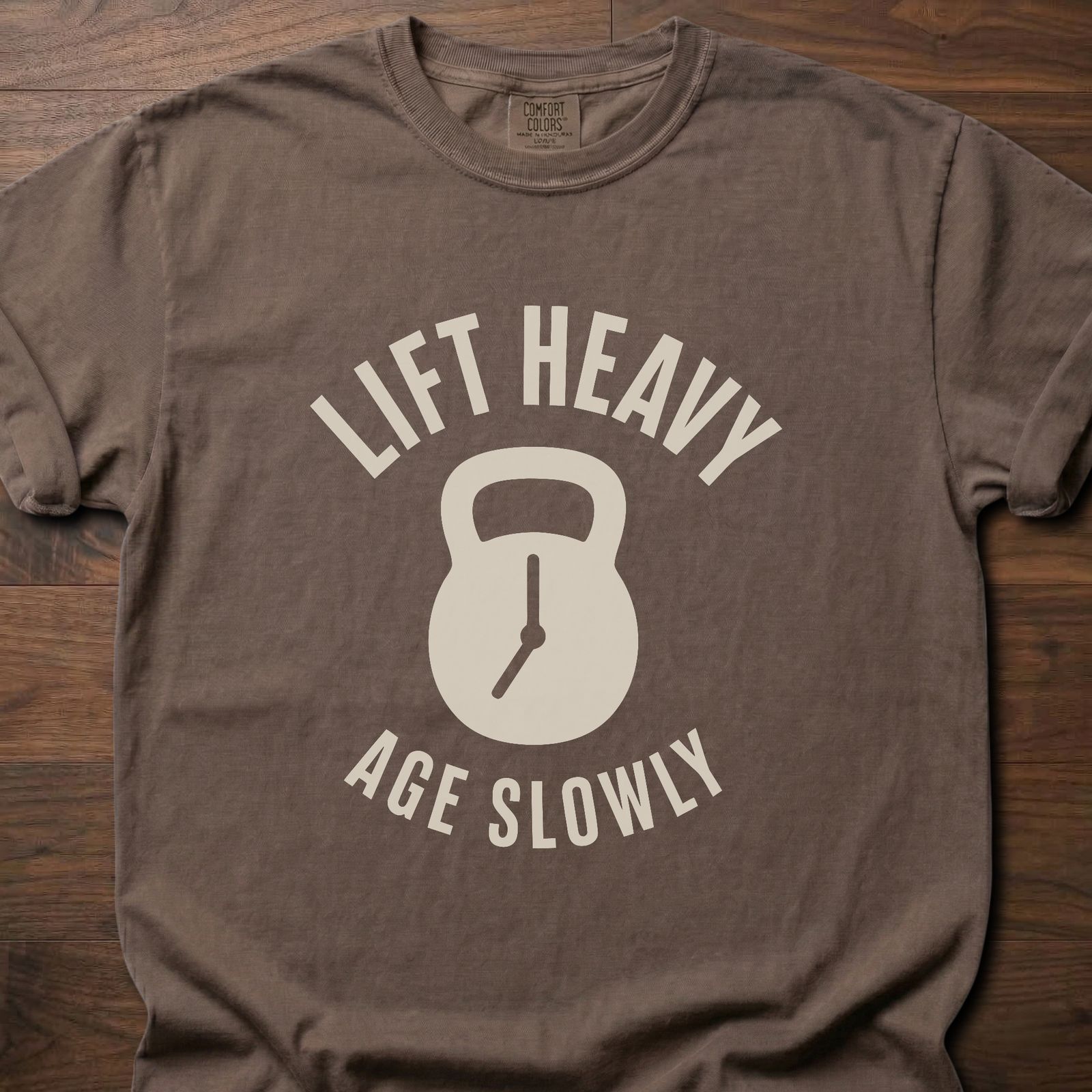 Lift Heavy Age Slowly strength training t-shirt with kettlebell and clock hands graphic – Espresso