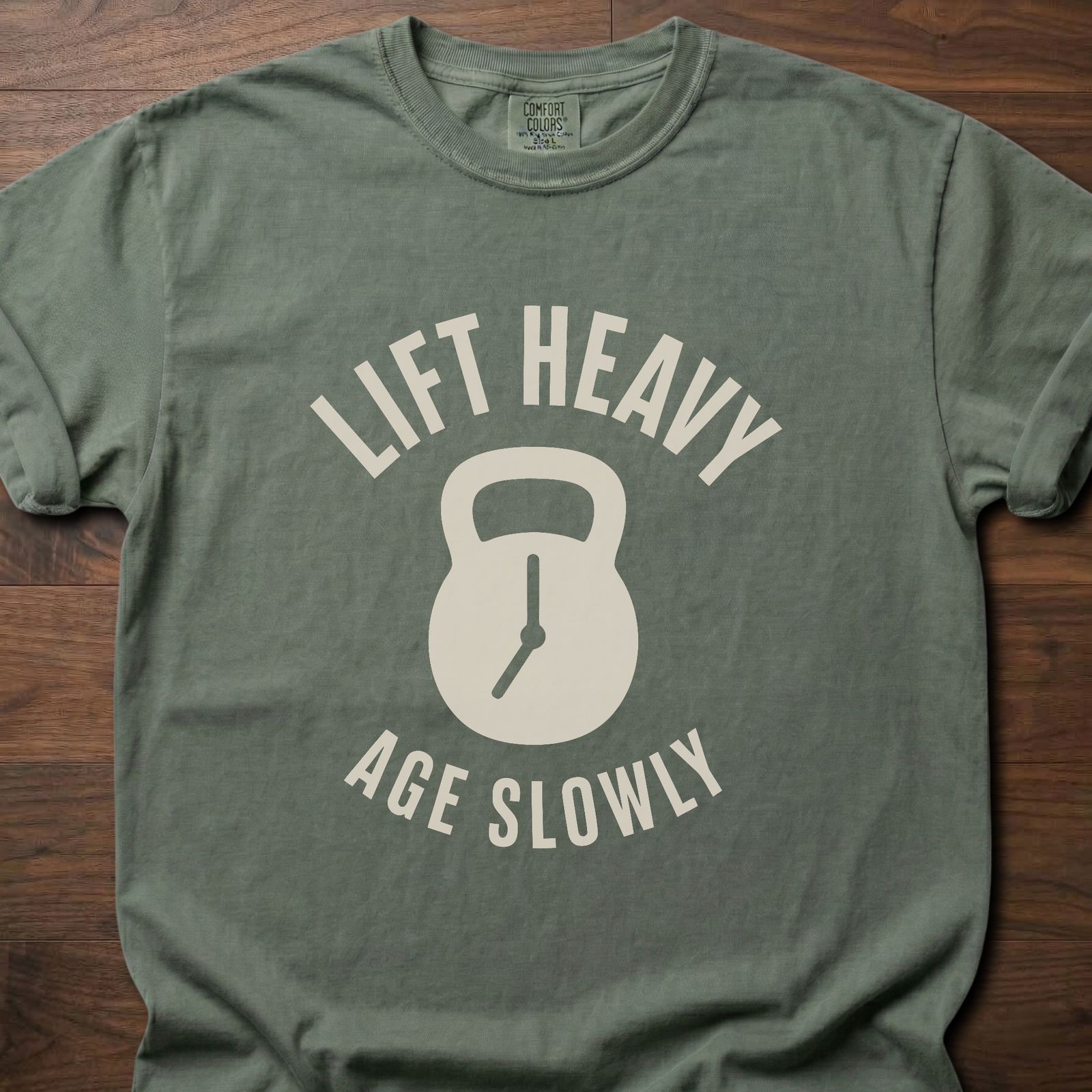 Lift Heavy Age Slowly strength training t-shirt with kettlebell and clock hands graphic – Moss