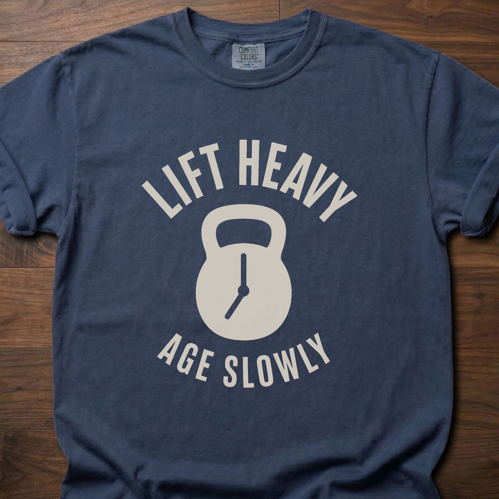 Lift Heavy Age Slowly strength training t-shirt with kettlebell and clock hands graphic – Navy