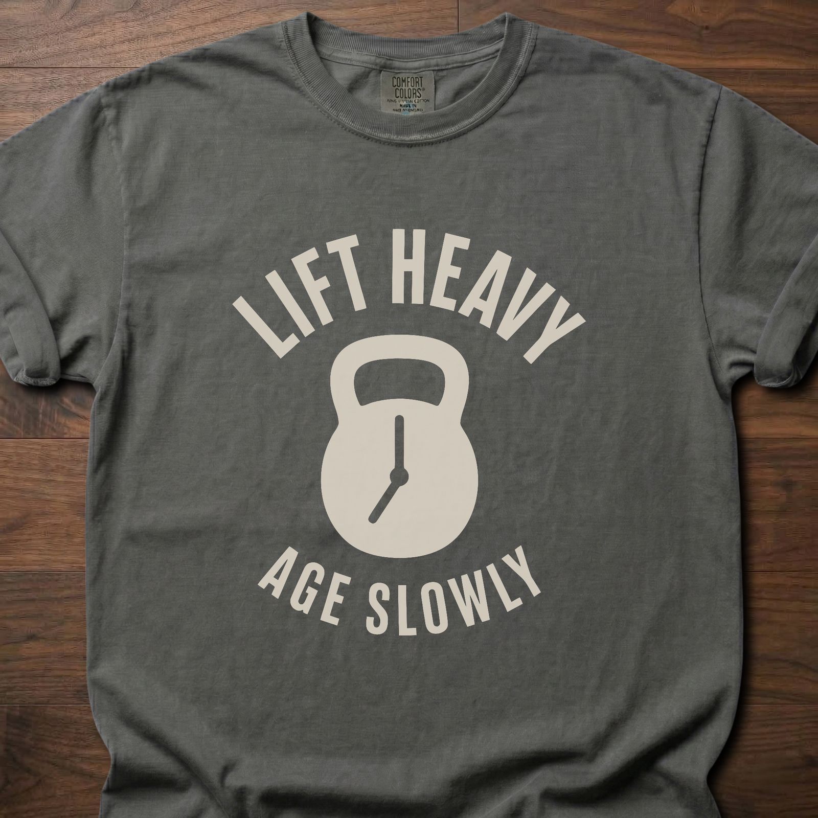 Lift Heavy Age Slowly strength training t-shirt with kettlebell and clock hands graphic – Pepper