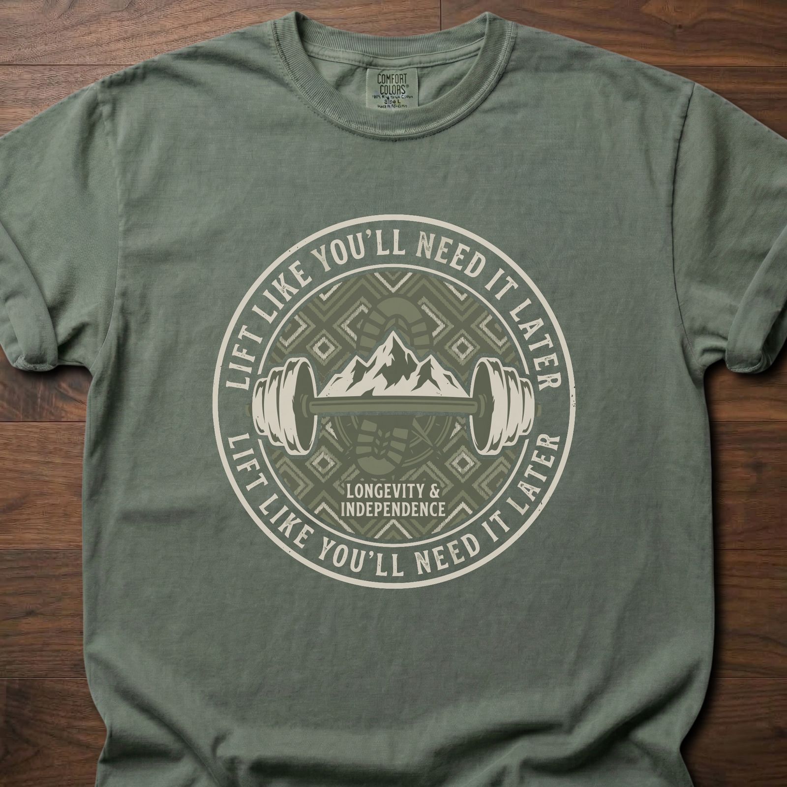 Lift Like You'll Need It Later strength training t-shirt with barbell and mountain badge design – Moss