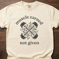 Muscle Earned fitness lifestyle apparel featuring crossed dumbbells with decorative floral design – Ivory