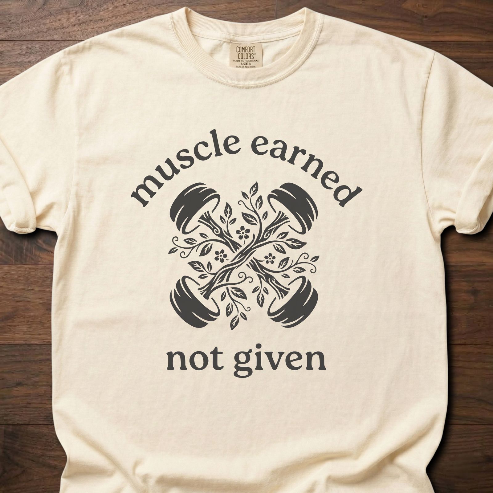 Muscle Earned fitness lifestyle apparel featuring crossed dumbbells with decorative floral design – Ivory