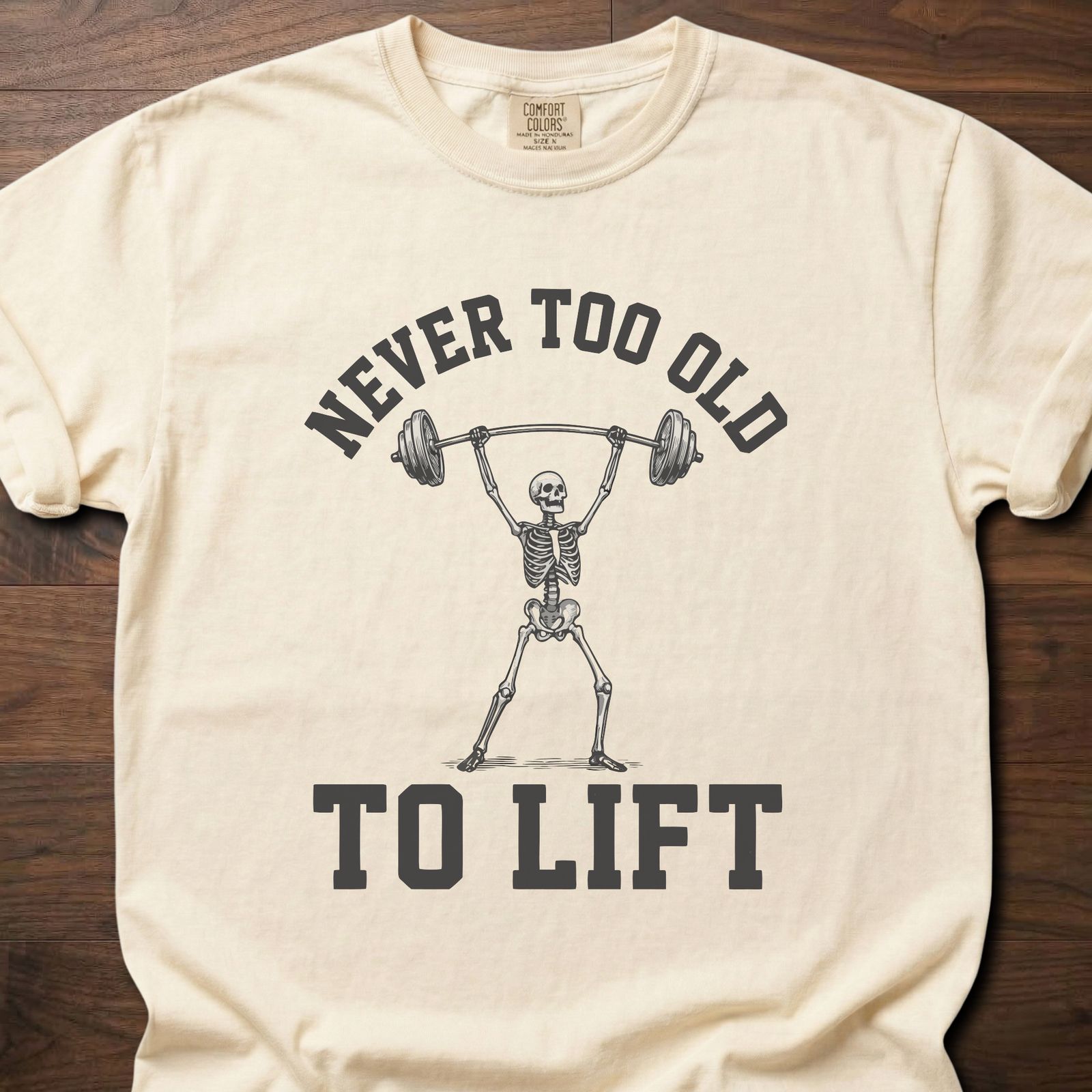 Never Too Old gym lifestyle shirt featuring skeleton lifting barbell overhead – Ivory