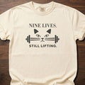 Nine Lives strength training lifestyle t-shirt with cat face and barbell graphic – Ivory