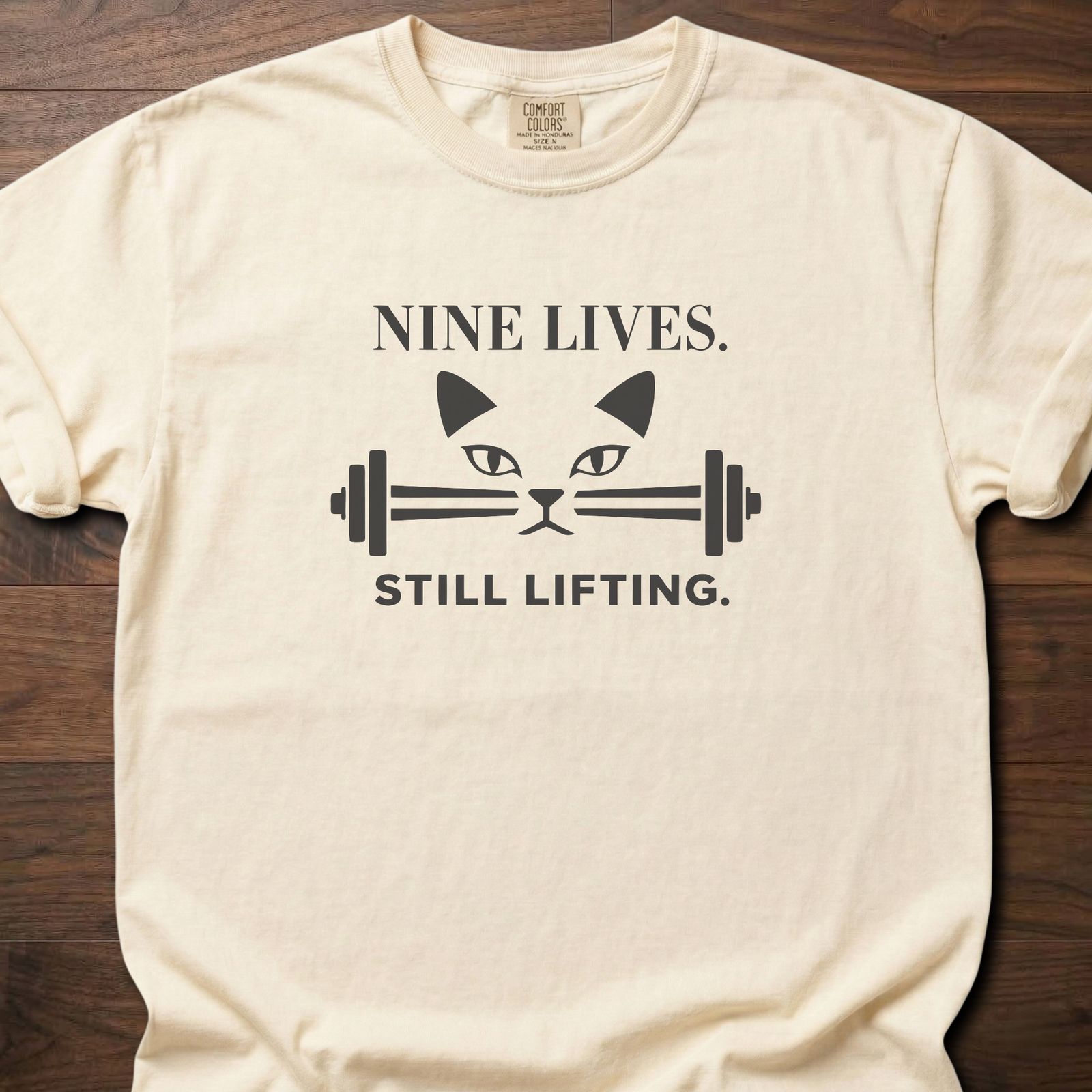 Nine Lives strength training lifestyle t-shirt with cat face and barbell graphic – Ivory