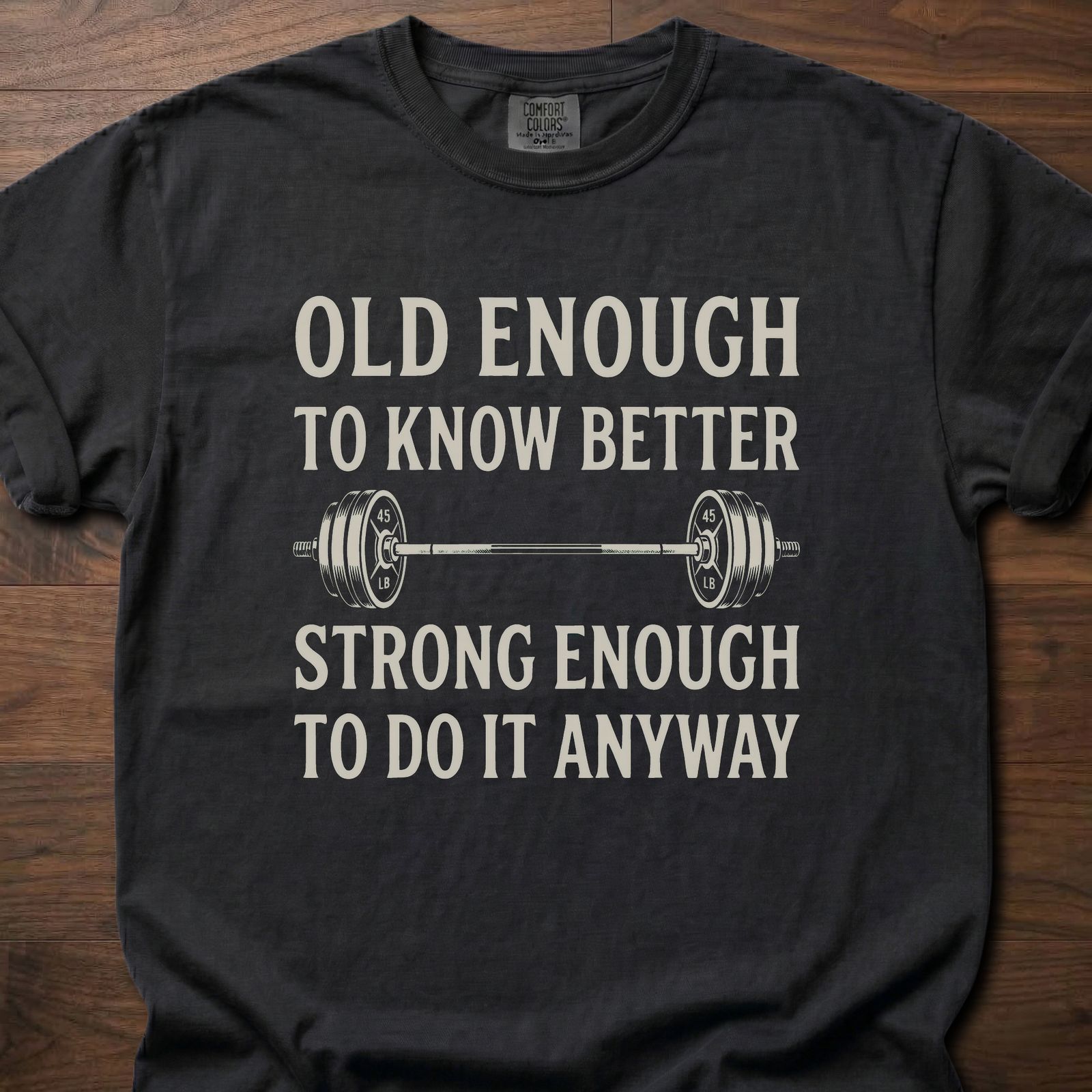 Old Enough T-Shirt featuring barbell graphic with humorous text about strength training lifestyle clothing – Black