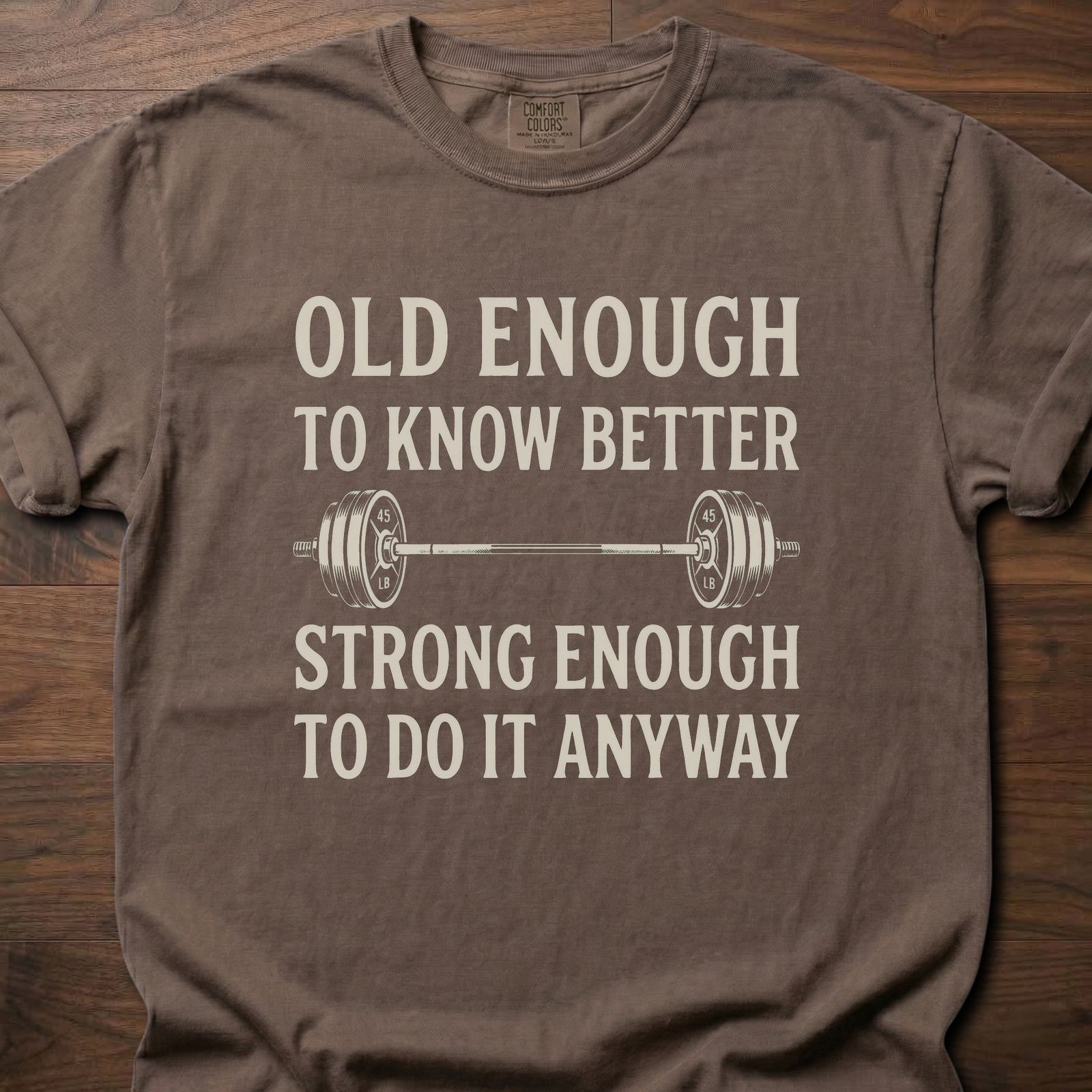 Old Enough T-Shirt featuring barbell graphic with humorous text about strength training lifestyle clothing – Espresso