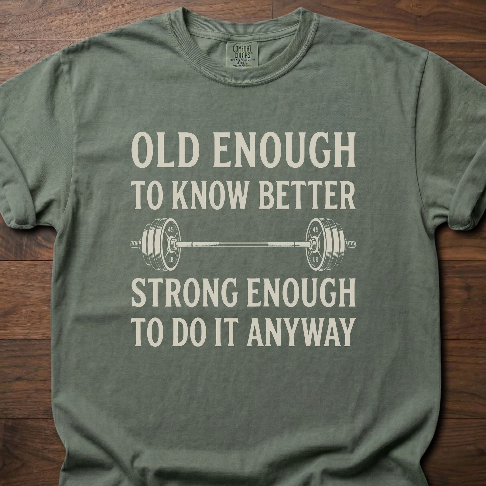 Old Enough T-Shirt featuring barbell graphic with humorous text about strength training lifestyle clothing – Moss