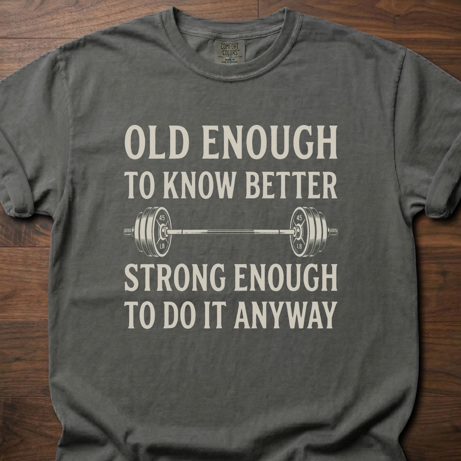 Old Enough T-Shirt featuring barbell graphic with humorous text about strength training lifestyle clothing – Pepper