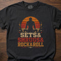 Sets And Shrugs T-Shirt featuring weightlifter silhouette with dumbbells and Rock&Roll text – Black
