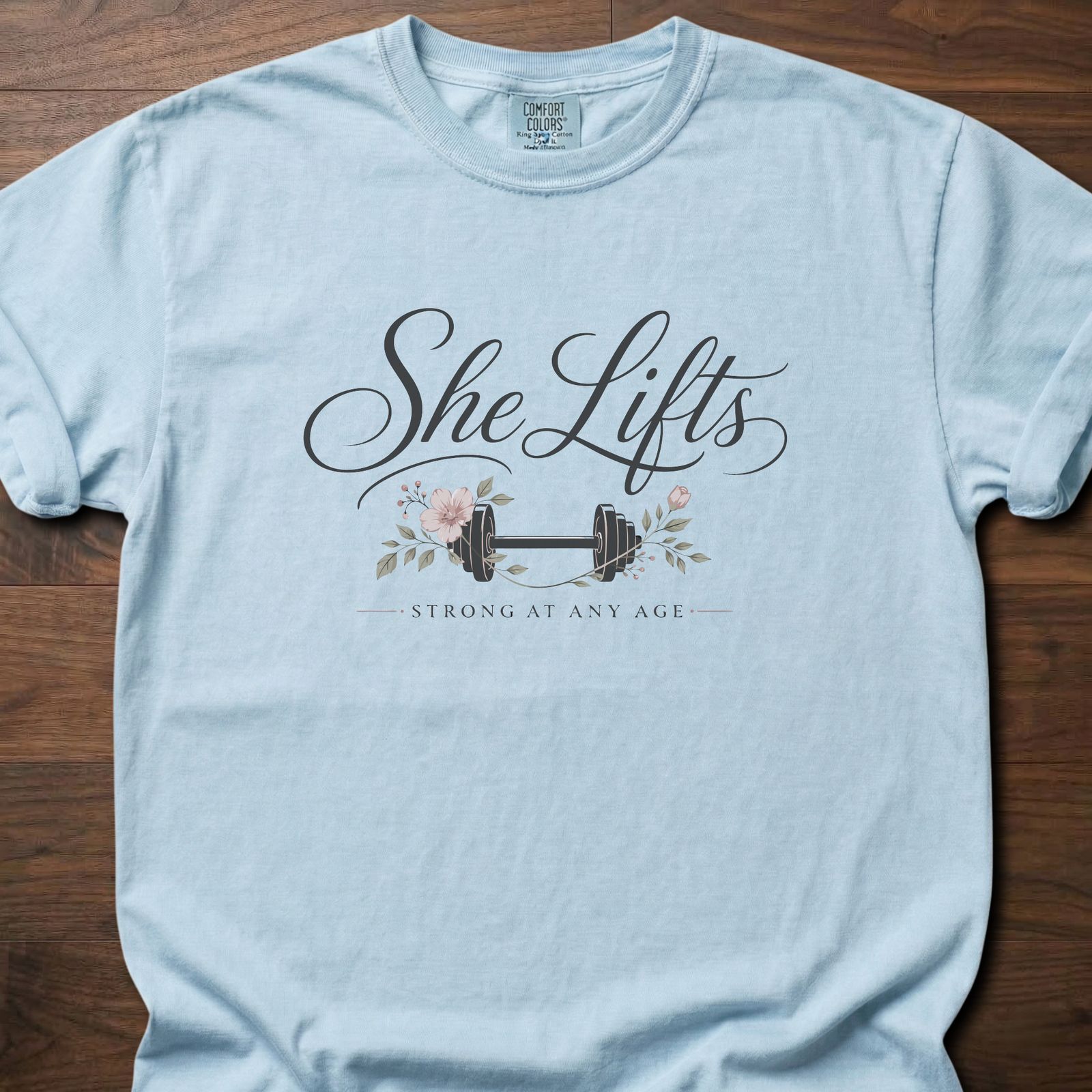 She Lifts strength training t-shirt with barbell and floral design – Chambray