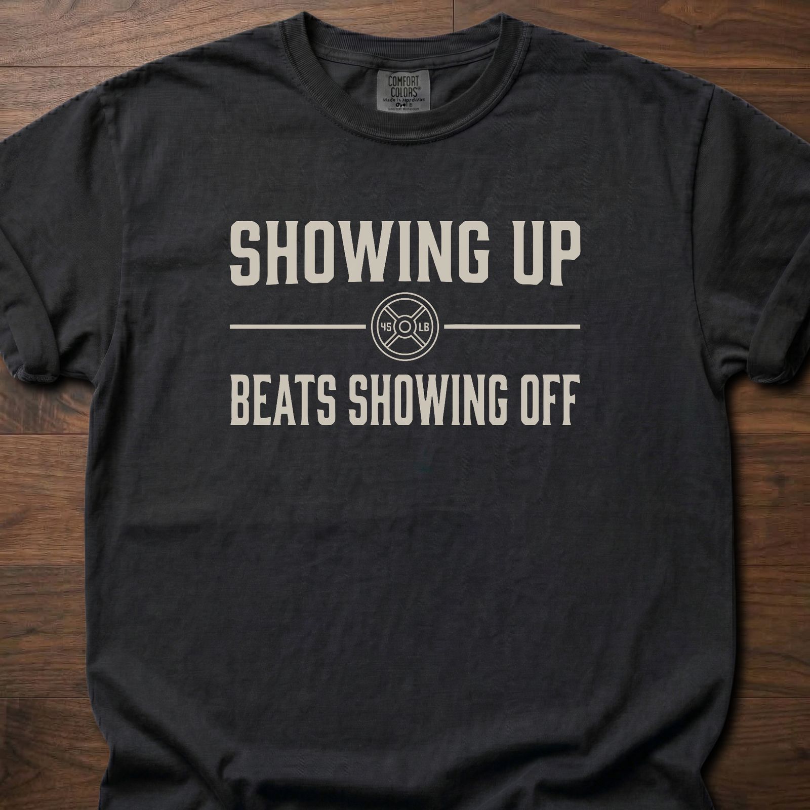 Showing Up strength training t-shirt with motivational message and weight plate design – Black